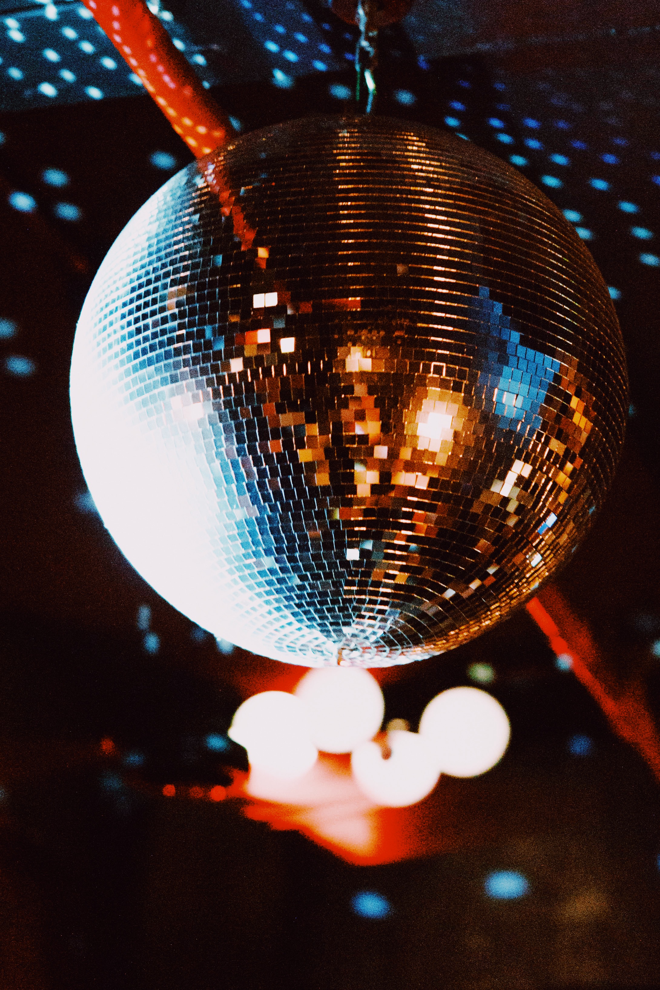 A glittering disco ball lighting up a dark club